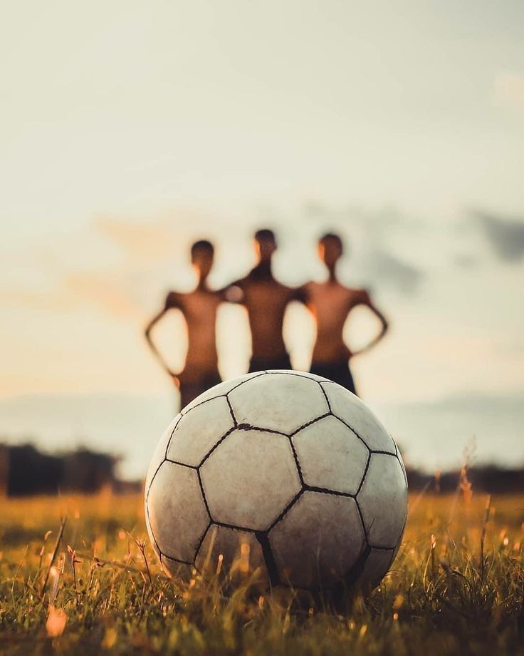 Soccer ball on grass at golden hour